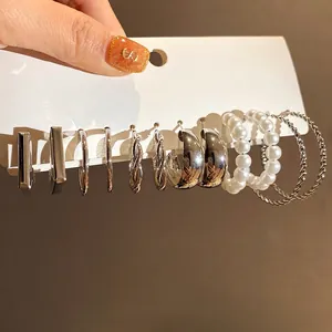 Elegant silver needle pearl earring set featuring retro twisted hoops and studs for women