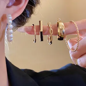 Elegant gold-plated and pearl earring set featuring multiple geometric and twisted hoops
