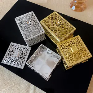 Close-up of ornate metal palace style jewelry boxes with exquisite hollowed-out vintage designs.