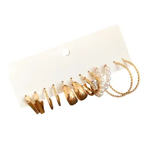 Vintage gold-toned earring set featuring elegant pearls and stylish twisted hoop designs