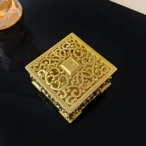 Close-up of ornate gold metal filigree jewelry box featuring exquisite palace style design