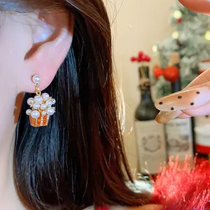 Close-up detail of a festive pearl popcorn earring featuring 18K gold plating and silver needle