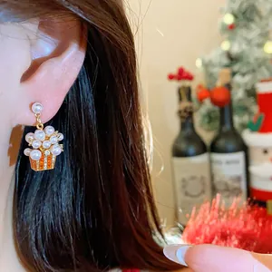 Close-up of elegant popcorn bucket earrings with pearls and 18K gold plating