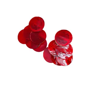Vibrant red tiered circular earrings with a modern minimalist shell-like texture finish.