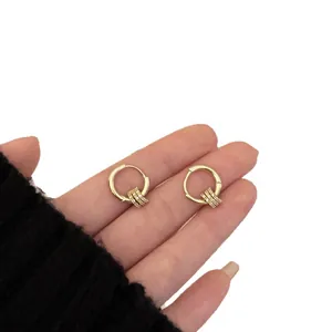 Elegant 18K gold hoop earrings featuring sparkling triple micro-pave dangling ring charms