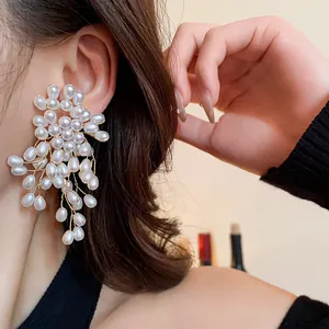 Detailed macro view of vintage-style flower pearl tassel earrings with silver needles