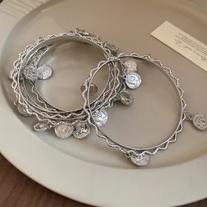 Silver geometric irregular wavy stacked bangle set with vintage coin charms for women