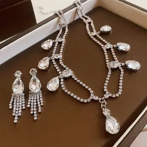 Close-up of sparkling waterdrop rhinestone tassel necklace and earring jewelry set