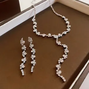 Detailed view of a sparkling rhinestone necklace and long tassel earring jewelry set
