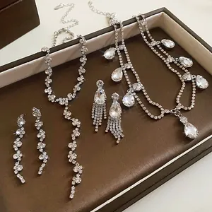 Detailed view of silver waterdrop fringe necklace and earring set in a jewelry box