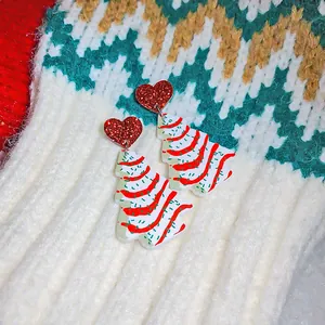 Close-up of sweet niche design heart and Christmas tree earrings with a red glitter finish