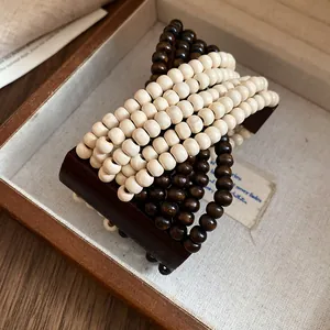 Dettaglio di un bracciale bohémien multistrato in perle di legno in uno scrigno