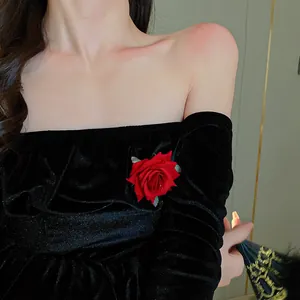 Detailed macro view of a sweet red rose flower duckbill hair clip on black velvet