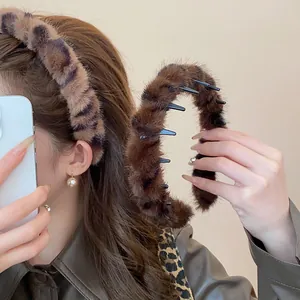 Close-up of plush leopard print headband with non-slip teeth for high cranial top effect