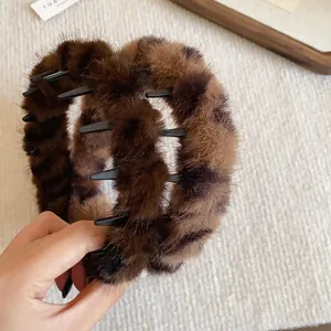 Close-up of vintage plush leopard print headband with inner teeth for high-top hair style