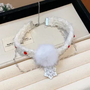 Detailed view of a white Christmas pom-pom necklace with a snowflake pearl pendant