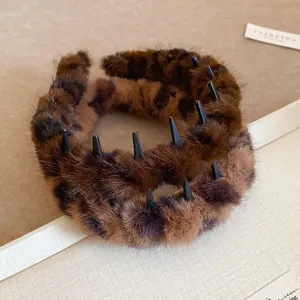 Close-up detail view of a fluffy leopard print plush headband with black grip teeth