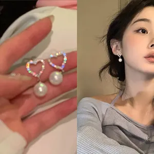 Close-up and model view of elegant heart-shaped zircon earrings with white pearls
