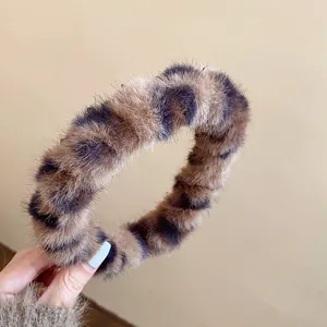 Detailed macro view of the fluffy leopard print plush headband with soft vintage texture