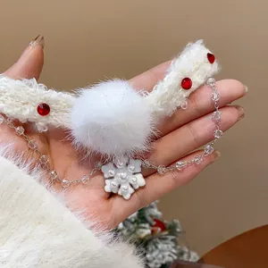Detailed view of Christmas snowflake necklace with white pom-pom and pearl pendant