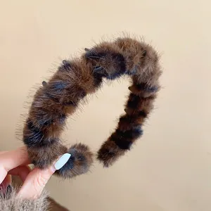 Detailed macro view of a vintage plush leopard print headband in Maillard style.