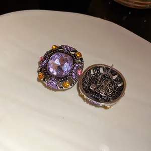 Close-up detail showing the front and back of vintage square purple crystal earrings