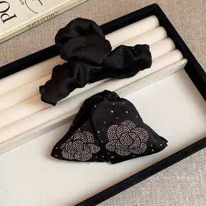 Elegant black fabric hair claw clip with sparkling rhinestone floral patterns for women