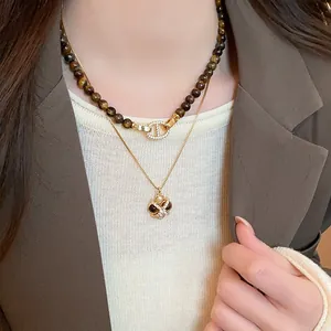 Close-up of a vintage tiger eye stone double-layer necklace with elegant gold finish