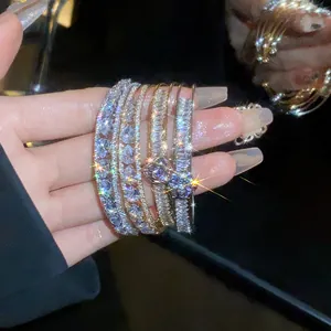 Close-up of sparkling zircon teardrop and rectangular double-layer stackable bangles