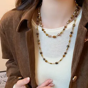 Detailed macro view of vintage brown tiger eye stone double-layer sweater necklace