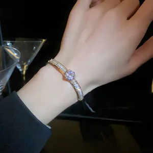 Close-up of sparkling zircon double-layer open bangle on wrist with macro details