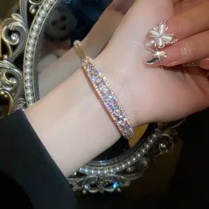 Detailed view of a luxury double-layer open bangle with sparkling teardrop zircons