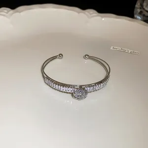 Detailed macro shot of silver double-layer cuff bracelet with sparkling zircon stones