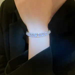 Detailed macro view of a luxury double-layer zircon open bangle with pear-shaped stones