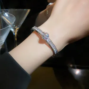 Close-up detail of luxurious silver bangle with sparkling zircon stones for women
