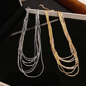 Elegant multi-layer real gold and silver plated necklaces on luxury black velvet display