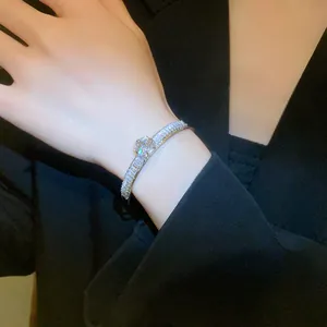 Detailed shot of an elegant double-row sparkling zircon open bangle on a wrist