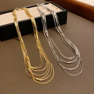 Close-up of multi-layer gold and silver plated necklaces with metallic luster
