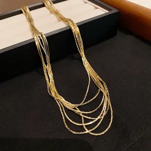 Detailed macro shot showing the fine texture of this gold-plated multi-layer necklace