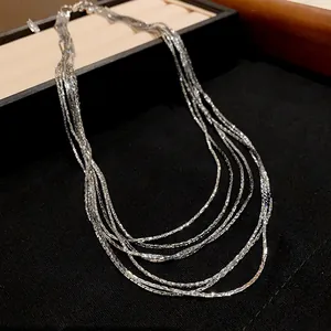 Detailed macro view of a shimmering multi-layered silver plated elegant necklace