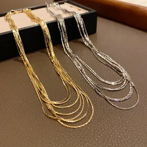 Detailed view of layered gold and silver chains with high-shine metallic texture