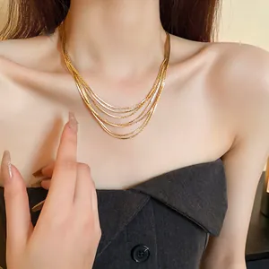 Detail shot of an elegant gold-plated multi-layer clavicle chain necklace on model