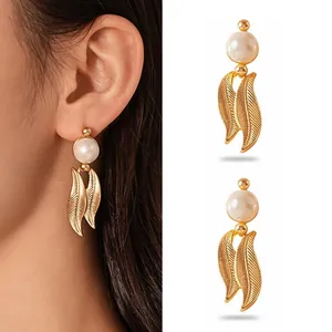 Elegant gold stainless steel stud earrings featuring pearls and textured leaf drops.