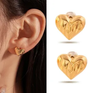 Detailed macro view showing texture of stainless steel gold heart stud earrings for women