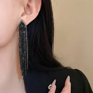 Sparkling black rhinestone fringe tassel earrings on a model for an elegant look.