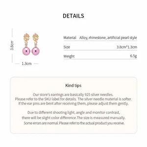 Detailed view of pink pearl earrings with rhinestone leaf design and size specifications.