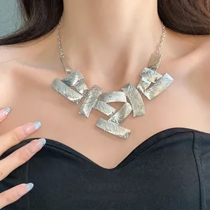 Statement geometric textured silver necklace with abstract rectangular metal pieces on model