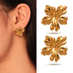 Detailed view of large golden stainless steel flower stud earrings showing petal texture