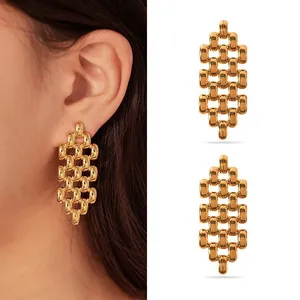 Detail view of gold-tone stainless steel mesh earrings showing intricate woven texture
