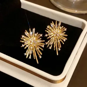 Sparkling gold fireworks starburst earrings with zircons for an elegant fashion statement